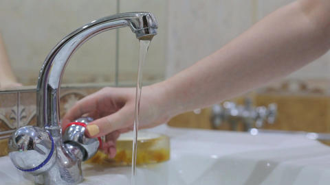Coronavirus pandemic prevention wash hands with soap warm water rubbing fingers