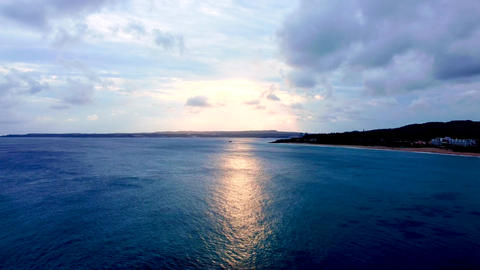 Drone flying over the sea at sunset landscape