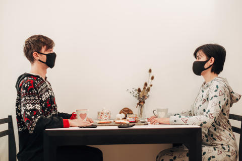 Girl and Guy Have Breakfast at Home in Masks