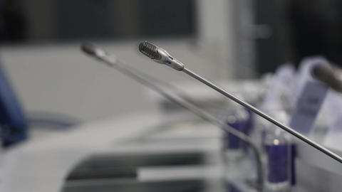 A stand with a microphone at a press conference. Portable microphone for speaker