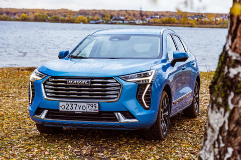 New blue color Haval Jolion at the edge of the river. All wheel drive suv at the nature