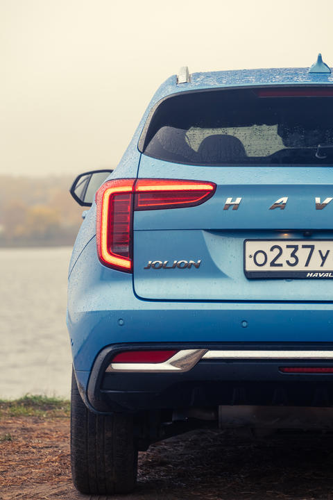 New blue color Haval Jolion at the edge of the river. All wheel drive suv at the nature