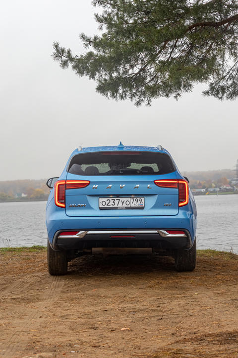 New blue color Haval Jolion at the edge of the river. All wheel drive suv at the nature