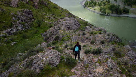 A traveler walks through the hills and takes photos and videos of the spectacular scenery