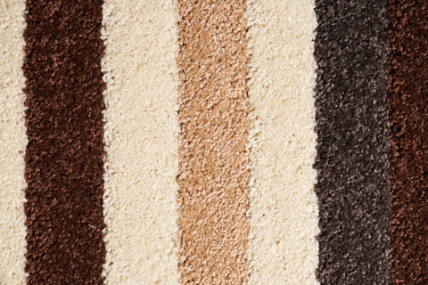 Motley striped carpet background, with thik pile wool texture