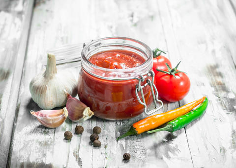 Tomato sauce in a jar and spices