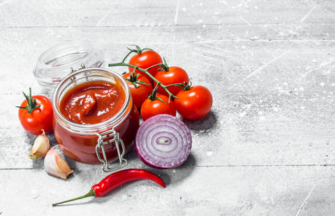 Tomato sauce in a jar with pepper, onion and garlic
