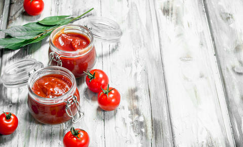 Tomato sauce in a jar with Bay leaf and tomatoes