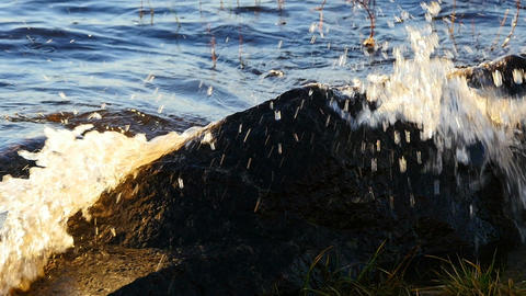 Tidal sea wave breaks with splashes on coastal stones, s GIF 23451558 ...