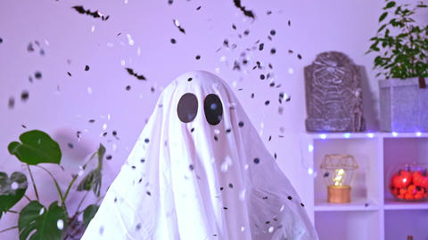 White ghost costume for Halloween party with neon lights in the background