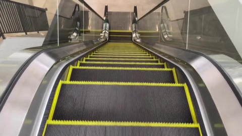 the moving black and yellow escalator