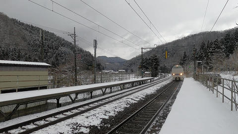 Express train passing through a winter station