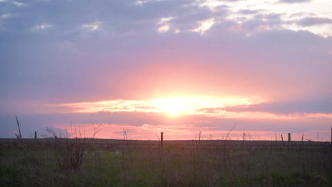 Time lapse of sunset with evening glow in the field