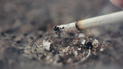cigarette burn gif shakes off the ashes from a burning cigarette. nicotine addiction. Bad