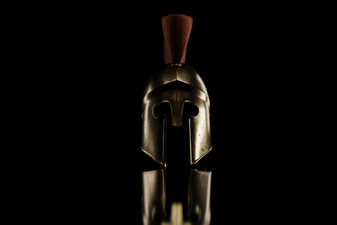 3d rendering of ancient greek Sparta type helmet in low key ligh