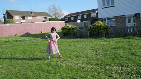 Young children, girl and boy, are playing frisbee in the open green area