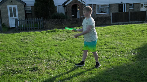 Young children, girl and boy, are playing frisbee in the open green area