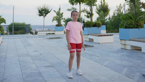 Athletic toddler kid jogger enjoy dancing in the park