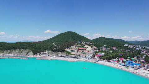 Aerial view of beach with tourists swimming in beautiful clear sea water