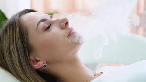 Woman Exhaling Smoke from Electronic