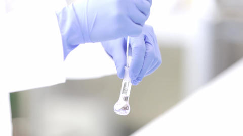 Young woman lab technician doing research at the modern laboratory, industrial