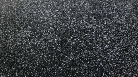 Icy Water Surface Covered with Snow Flakes