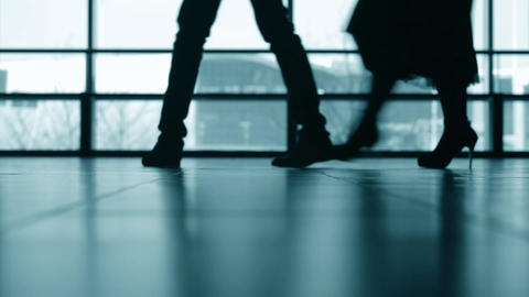 Silhouette of group of people walking at airport terminal
