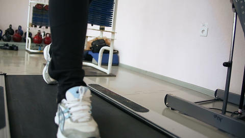 The girl running on the machine at the gym. Fitnes