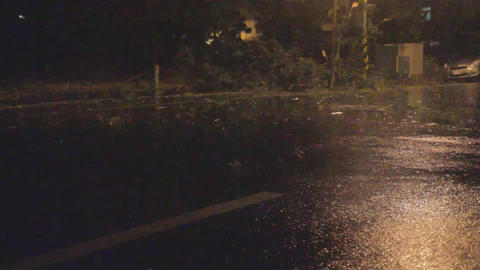 Typhoon blowing debris around on road