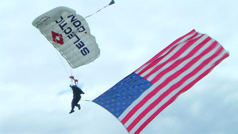 Skydiver Parachuting With Flag