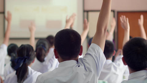 Asian high school students in white uniform actively study science by raising their hands