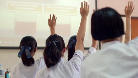 Asian high school students in white uniform actively study in science classroom