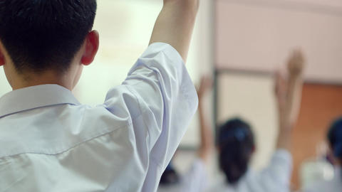 Asian high school students in white uniform actively study in science classroom