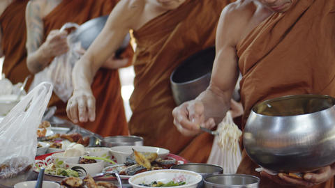 The Buddhist monks scoop or take the foods