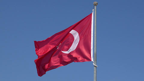 National Turkish flag waving at clear blue sky background slow motion close-up