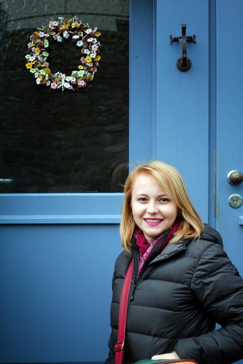 Young Woman Standing near her New House Door