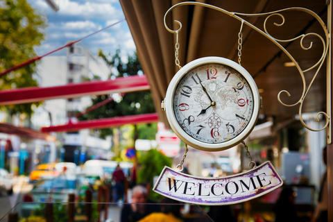 Welcome Sign Hanging on Wall Clock