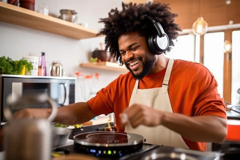 A man with headphones is cooking in a kitchen created with Generative AI technology