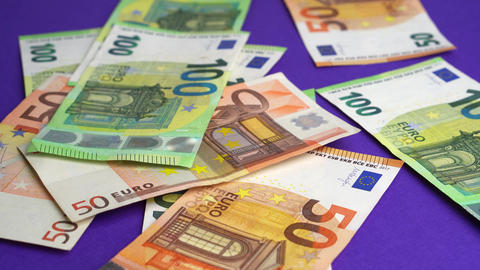 Money falling on table. Dropping lot of one hundred and fifty Euro paper