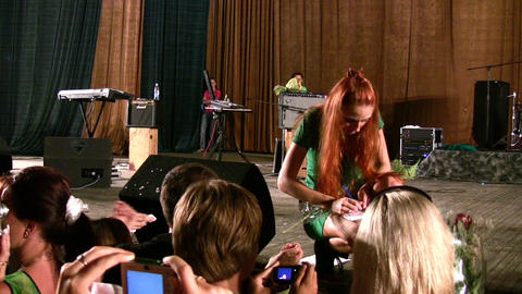 singer making autograph