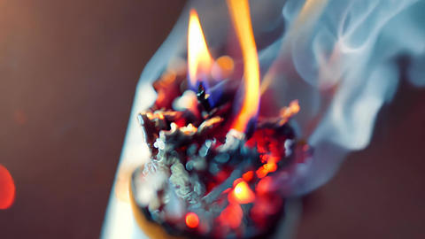Glowing Cigarette Ash with Rising Smoke and