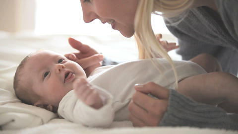 Woman holding and kissing a baby
