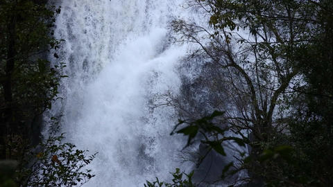 Sirithan Waterfall in rainy season with a misty, foggy atmosphere