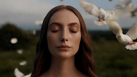 Aromatic white woman with white doves and falling petals