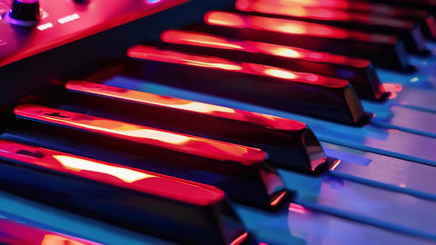 Vibrant close-up of piano keys with colorful lighting effects