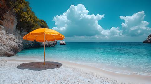 Sunny beach with a lone yellow umbrella and turquoise waters