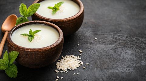 Creamy rice porridge in rustic bowls garnished with mint