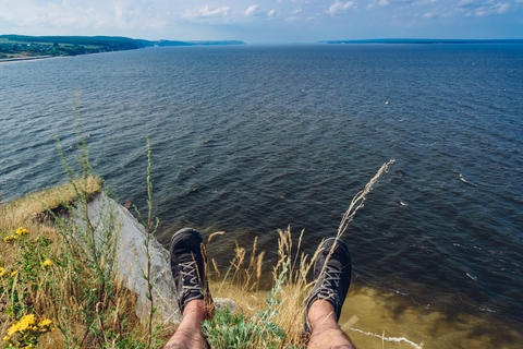 point of view of man sitting on the edge of cliff