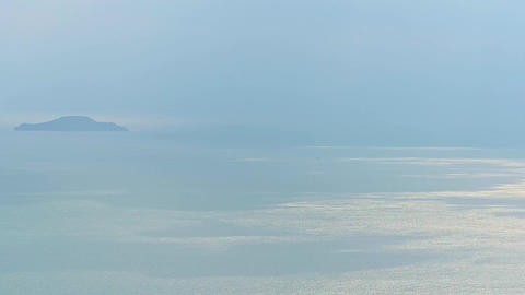 Calm sea and distant island Peaceful scenery stock footage