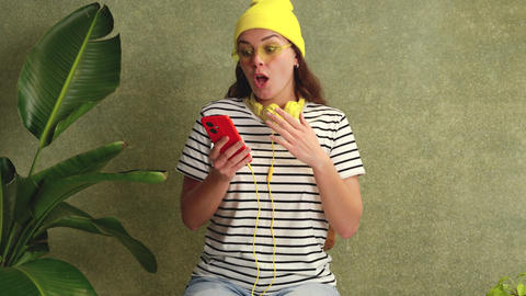 Excited Young Woman Reacting to Good News on Smartphone